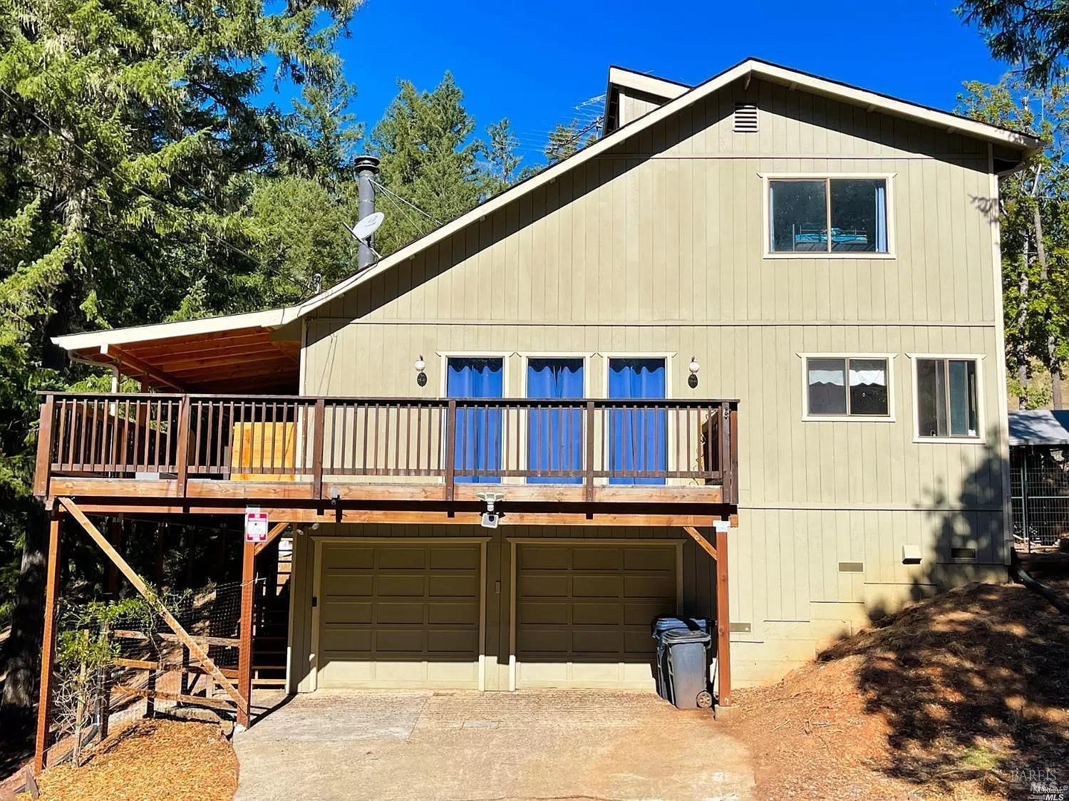 a view of a house with wooden deck