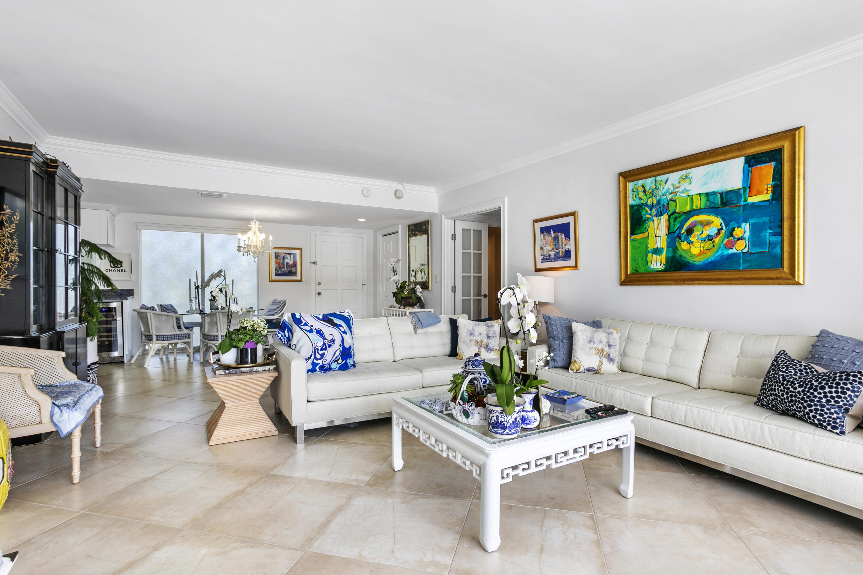 a living room with furniture and a painting on the wall