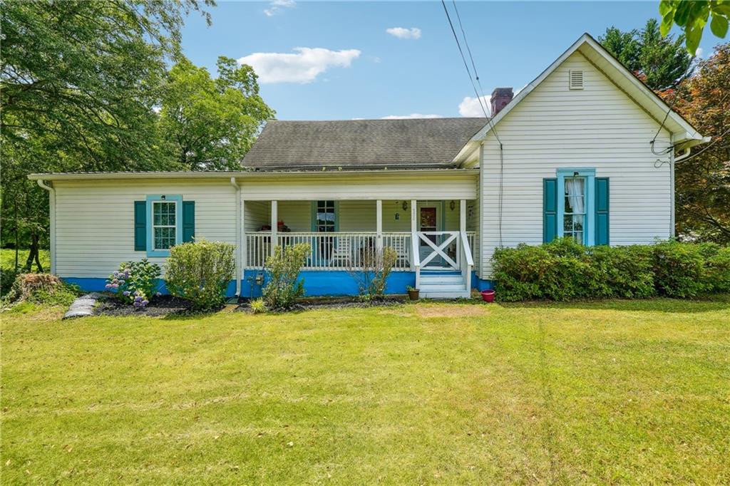 a view of a house with swimming pool and a yard