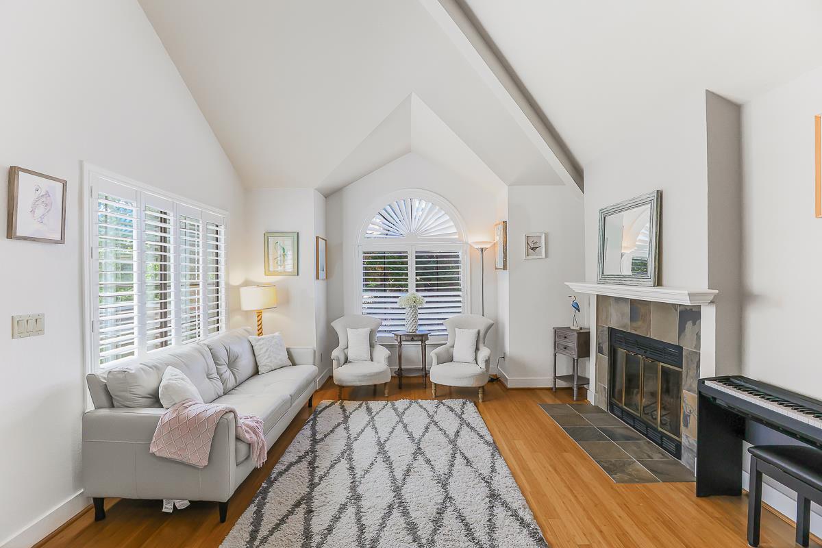 a living room with furniture fireplace and flat screen tv