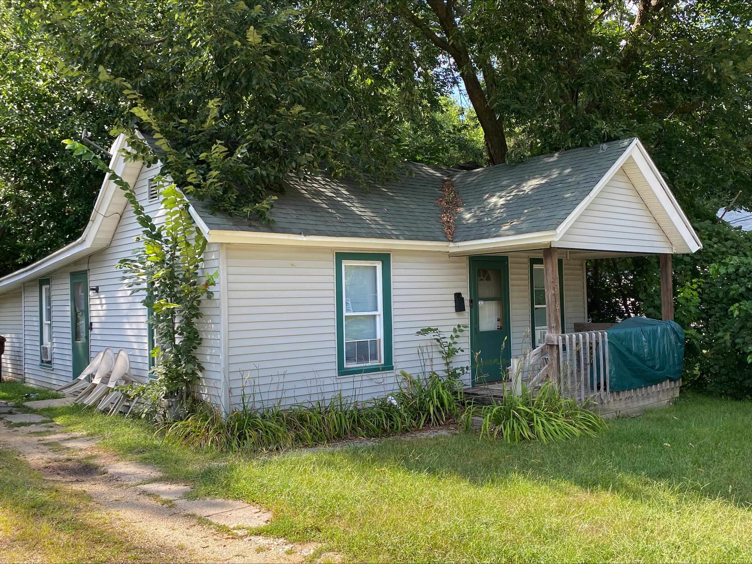 a view of a house with a yard and plants