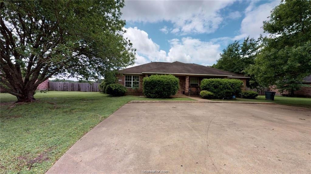 Ranch-style home with a front lawn