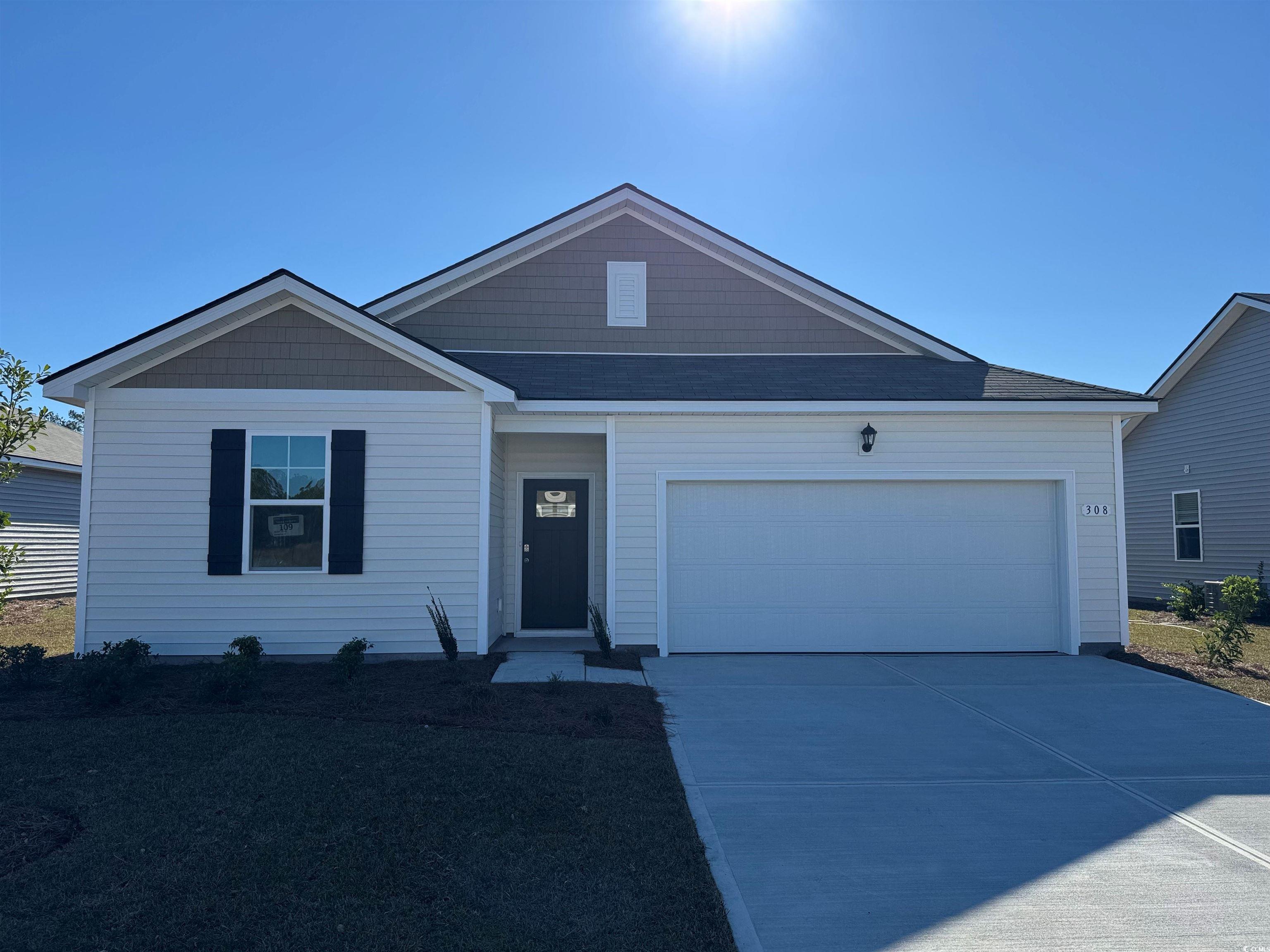 View of front facade featuring a garage