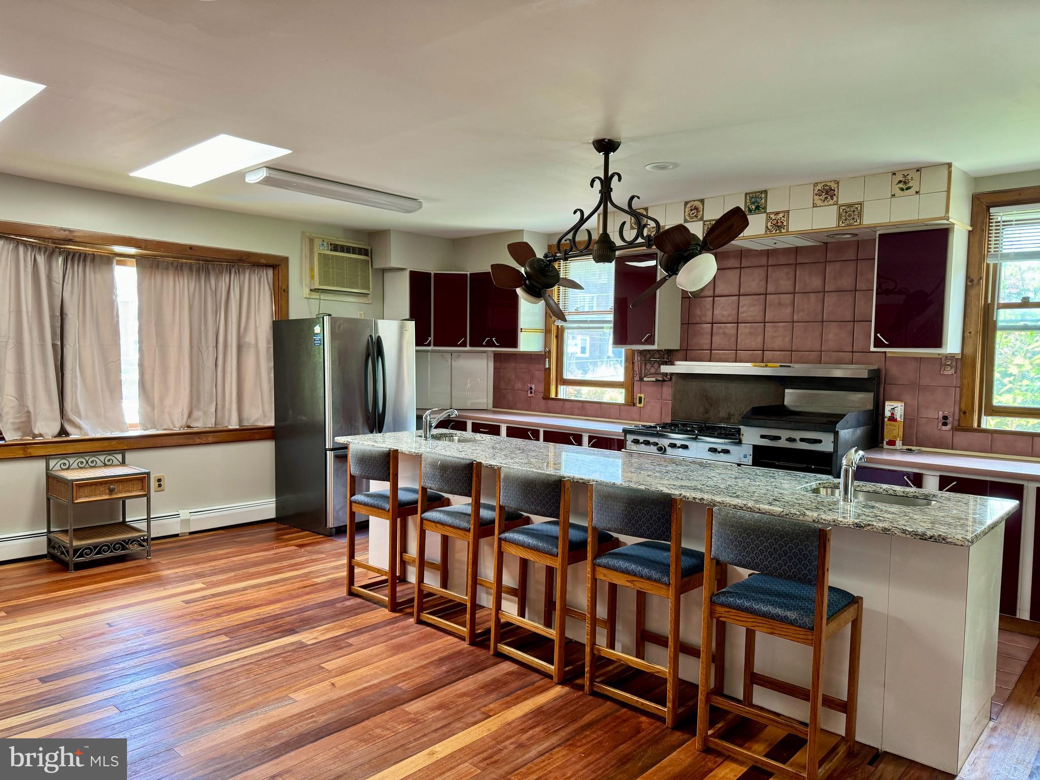 a kitchen with stainless steel appliances granite countertop a stove and cabinets