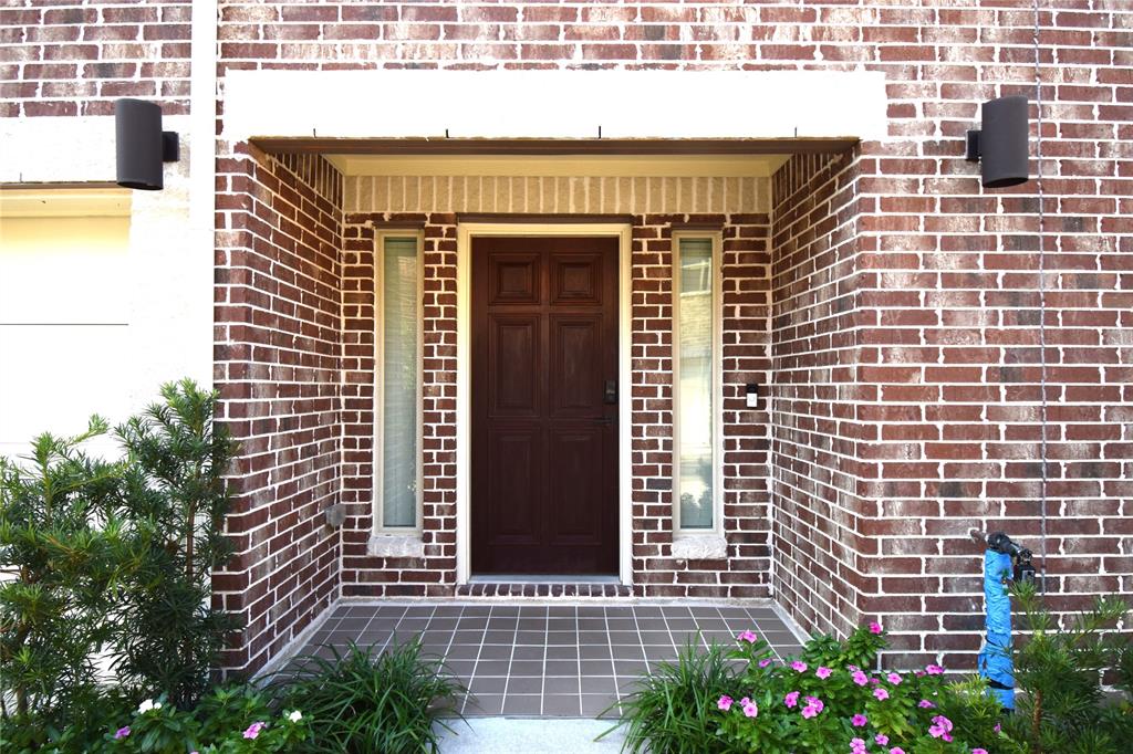 a front view of a house with plants