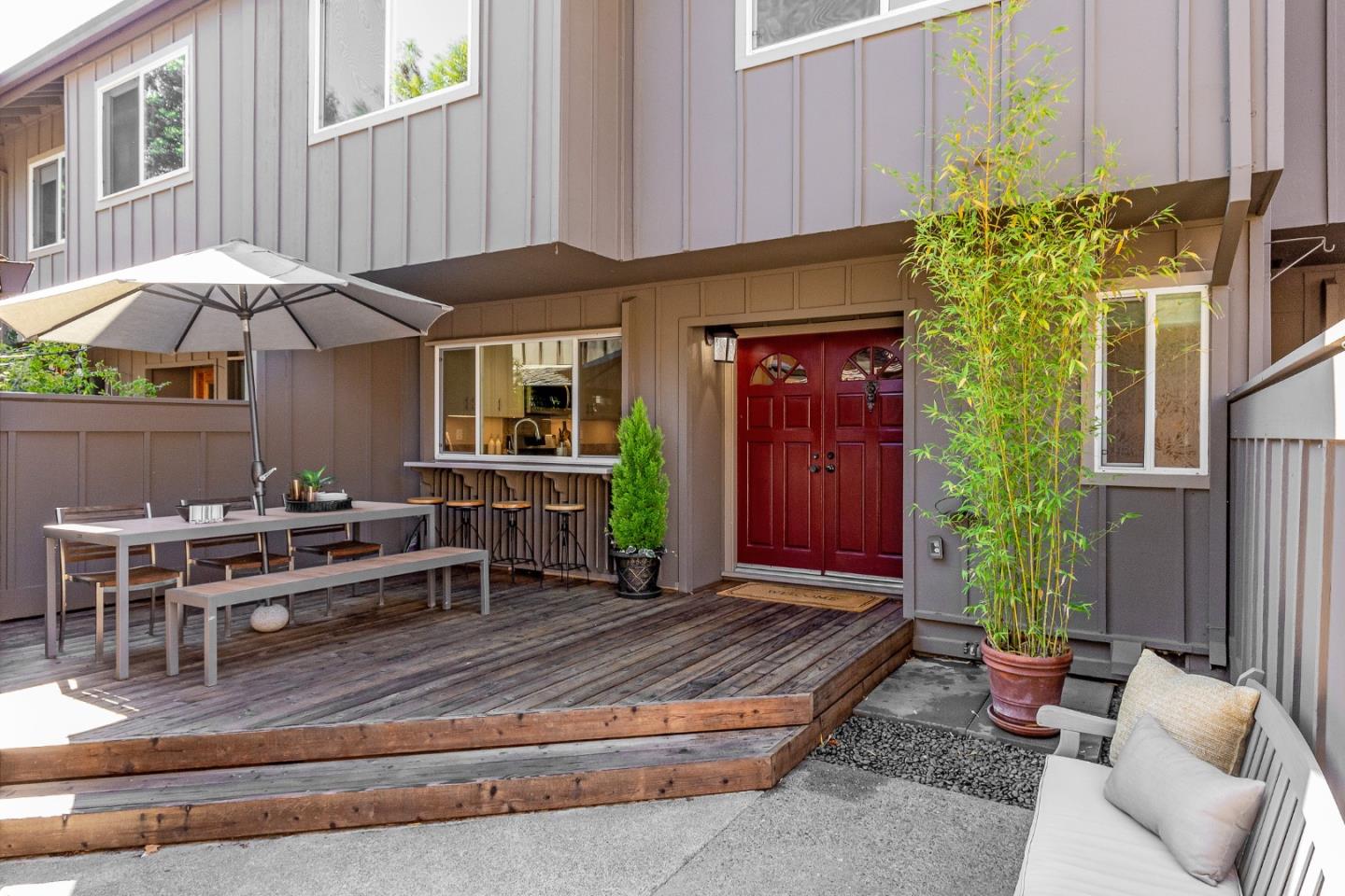 a view of a house with backyard and sitting area