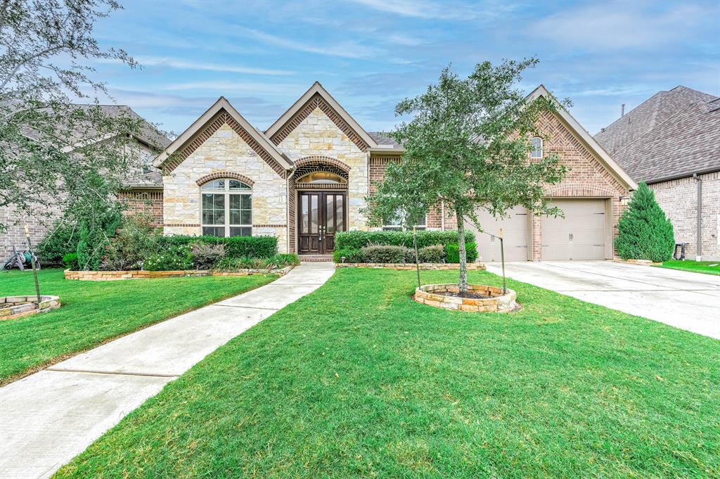 a front view of a house with a yard and garage