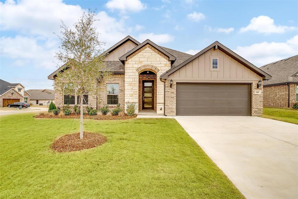 a front view of a house with a yard and garage