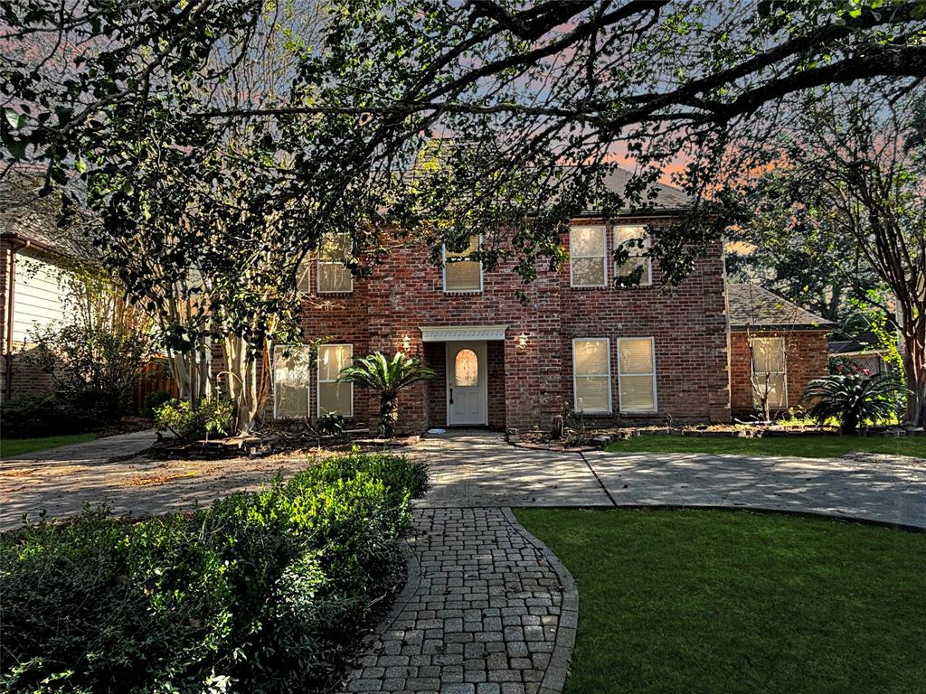 a front view of a building with a yard