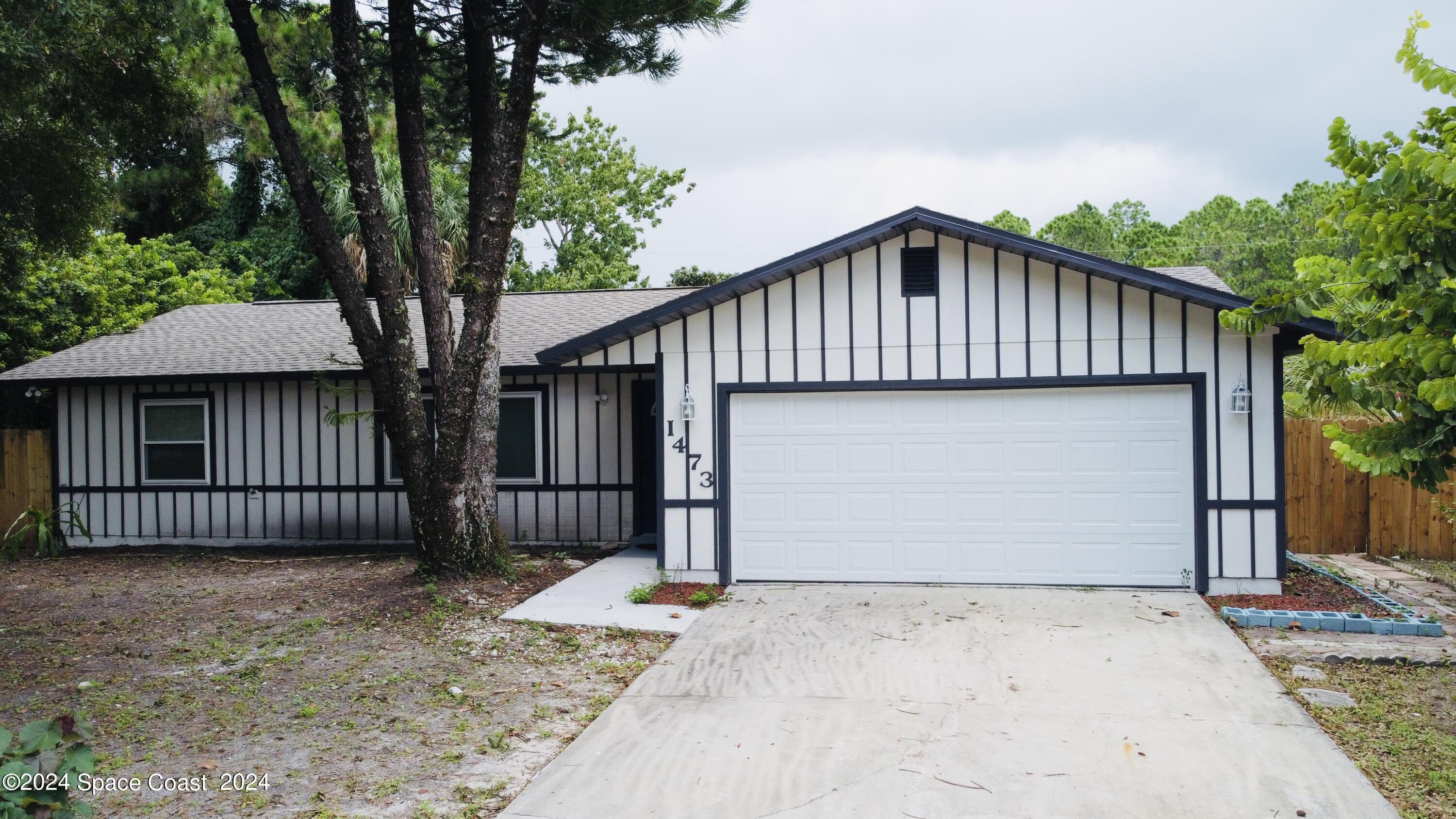 a front view of a house with a garage