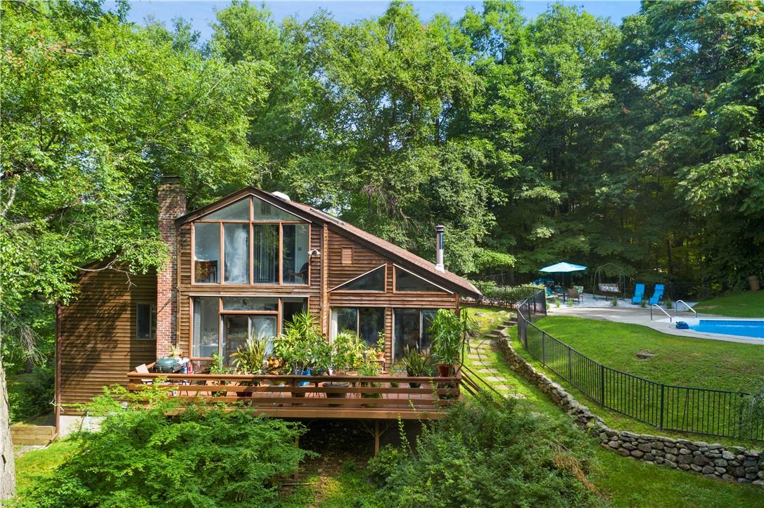 a aerial view of a house with swimming pool next to a yard