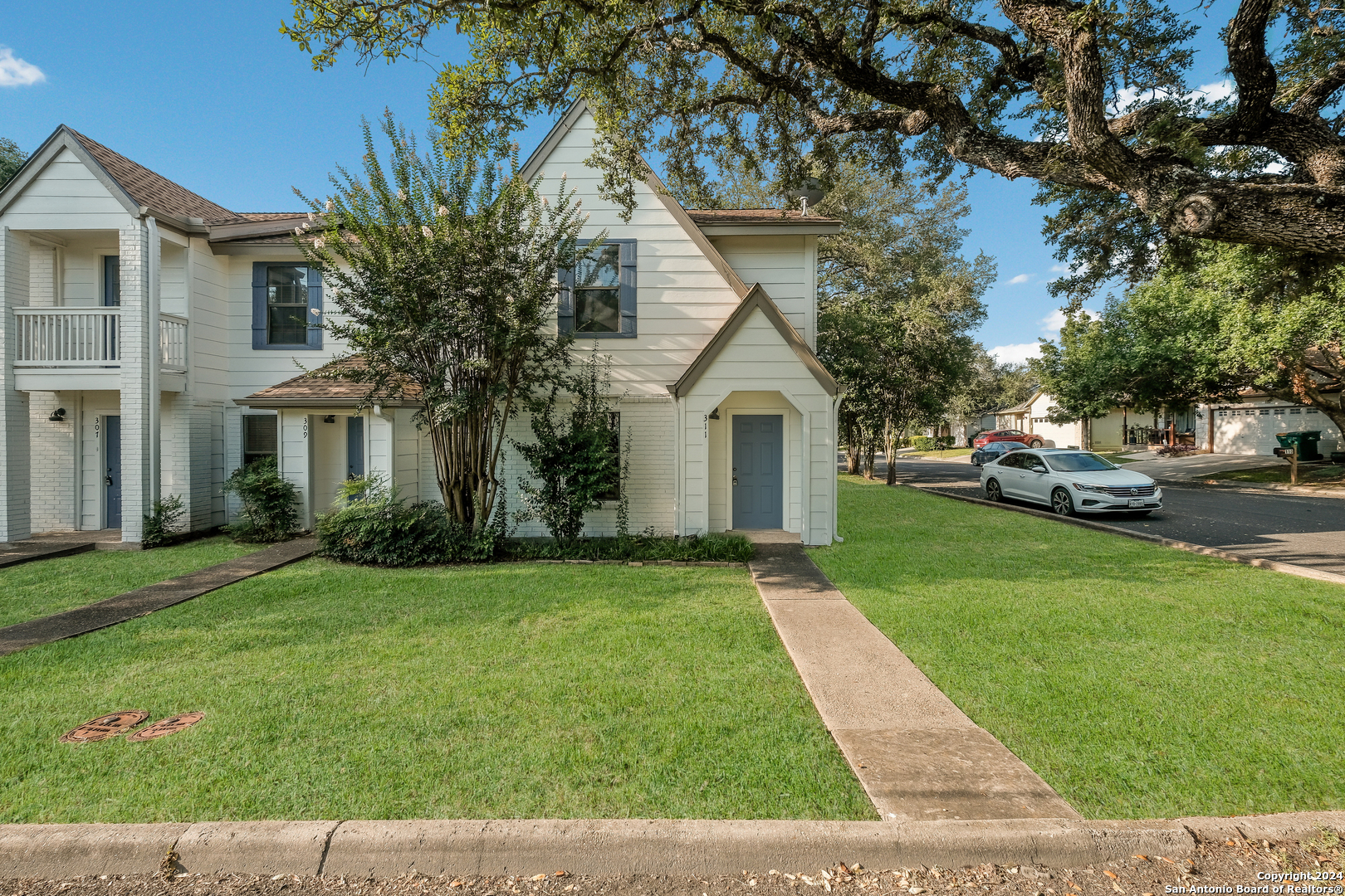 a front view of a house with a garden