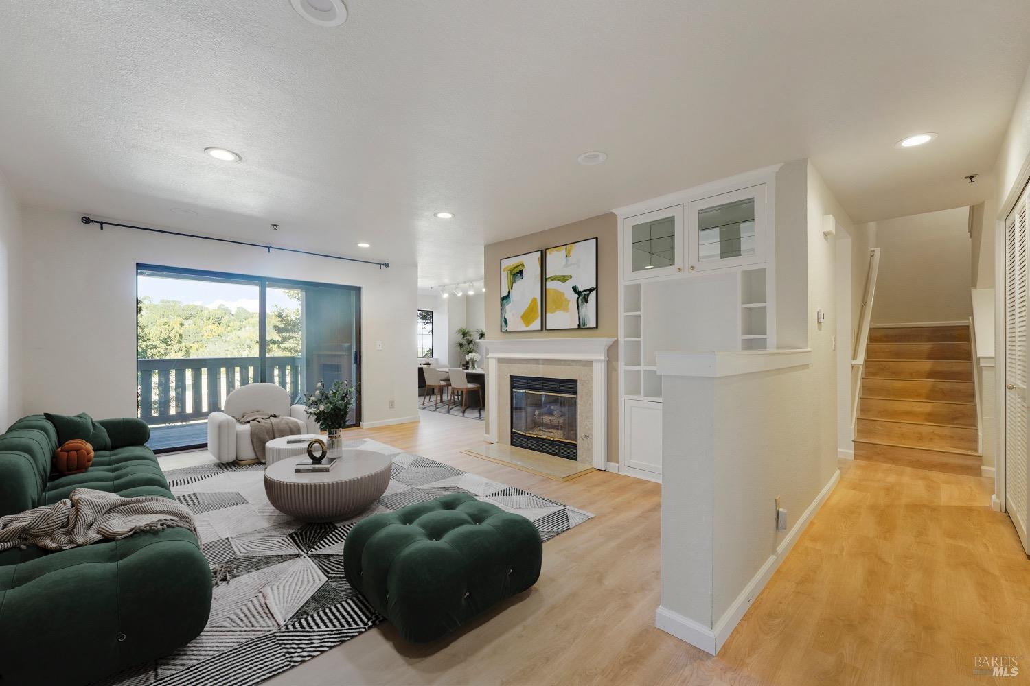 a living room with furniture a fireplace and a potted plant