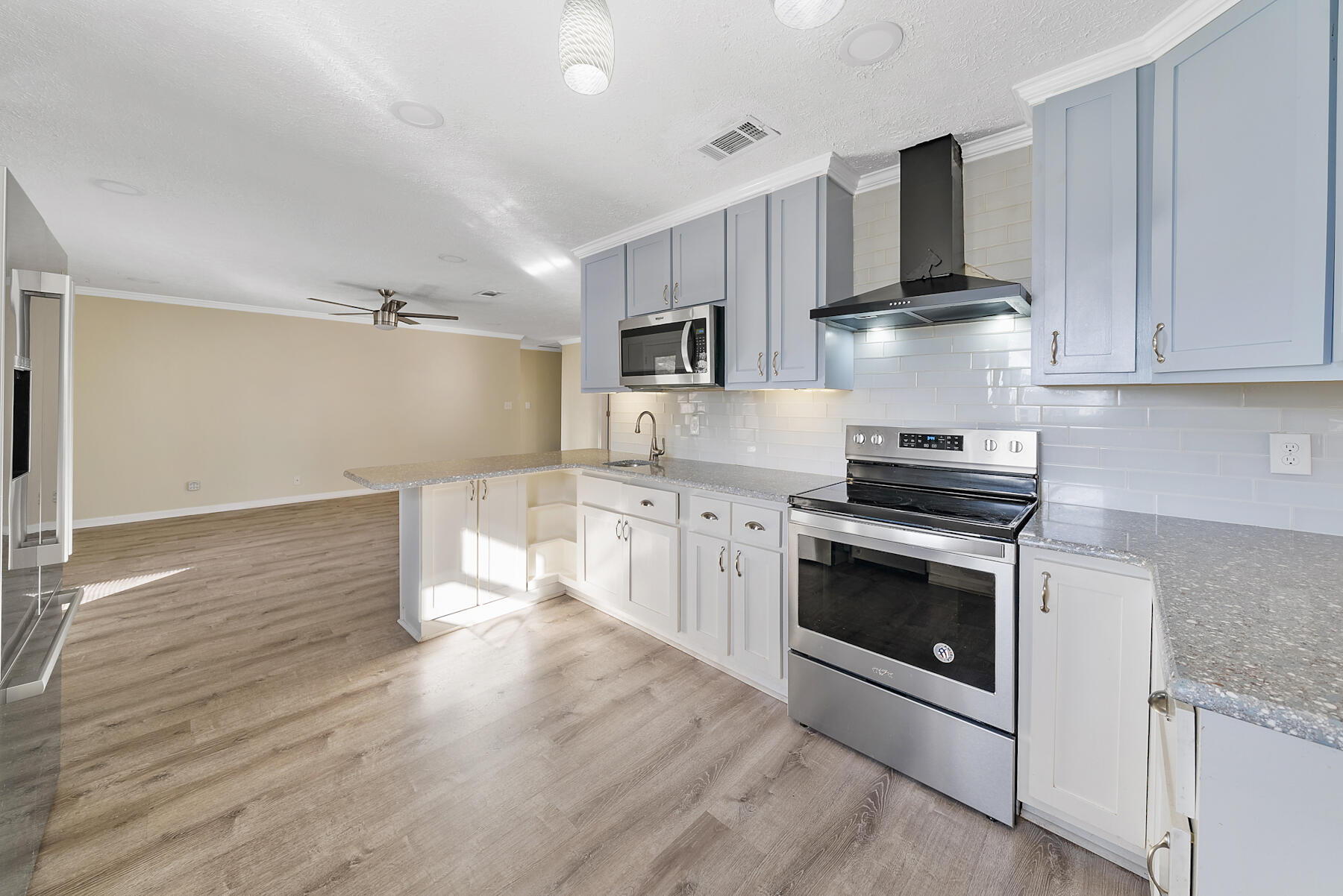 a kitchen with stainless steel appliances a stove a sink and a refrigerator