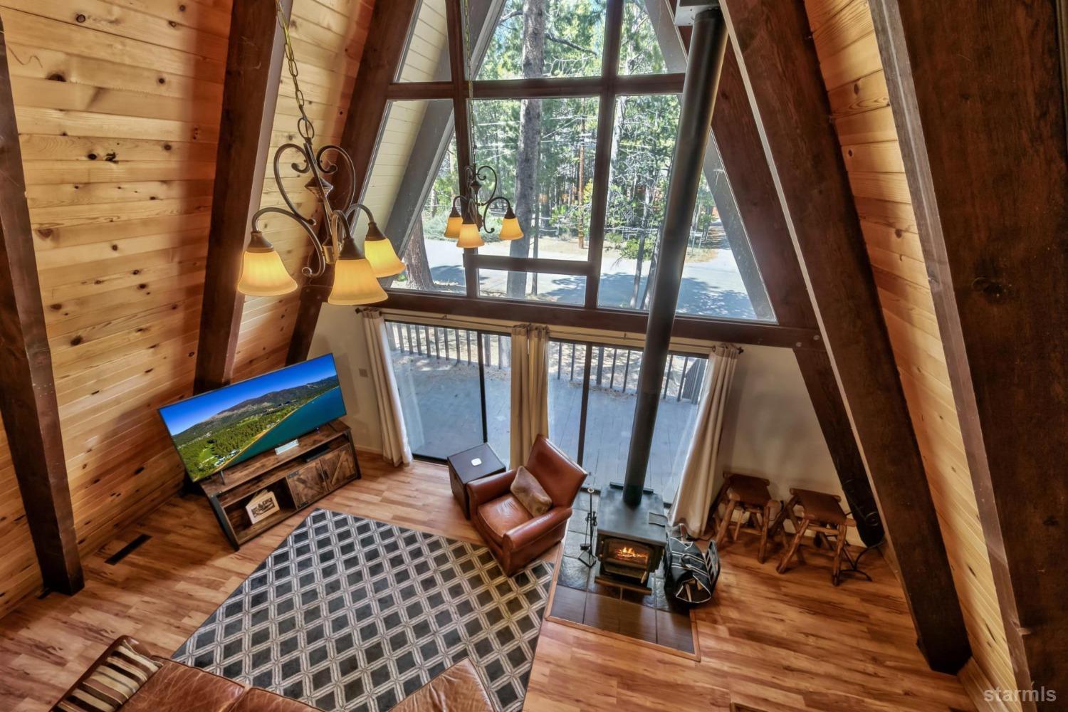 a living room with furniture and a floor to ceiling window