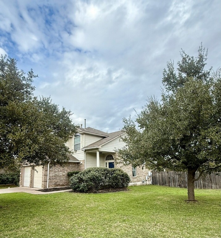 a front view of house with yard and green space