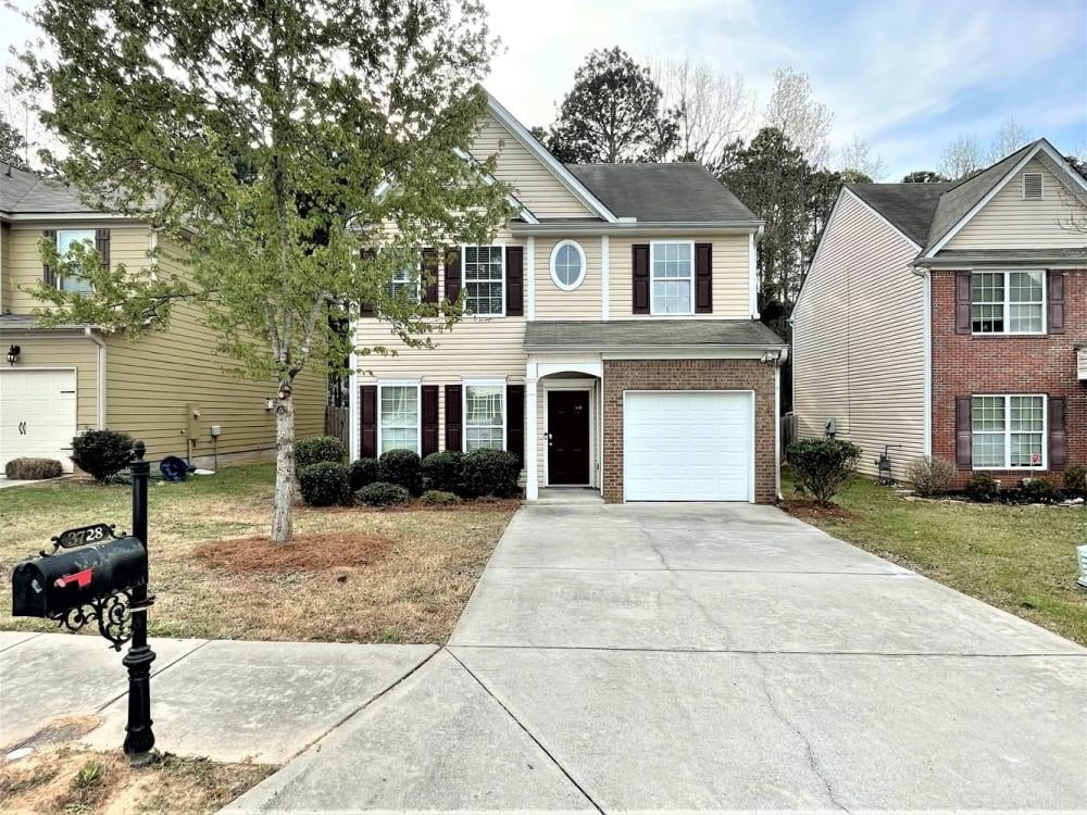 a front view of a house with a yard