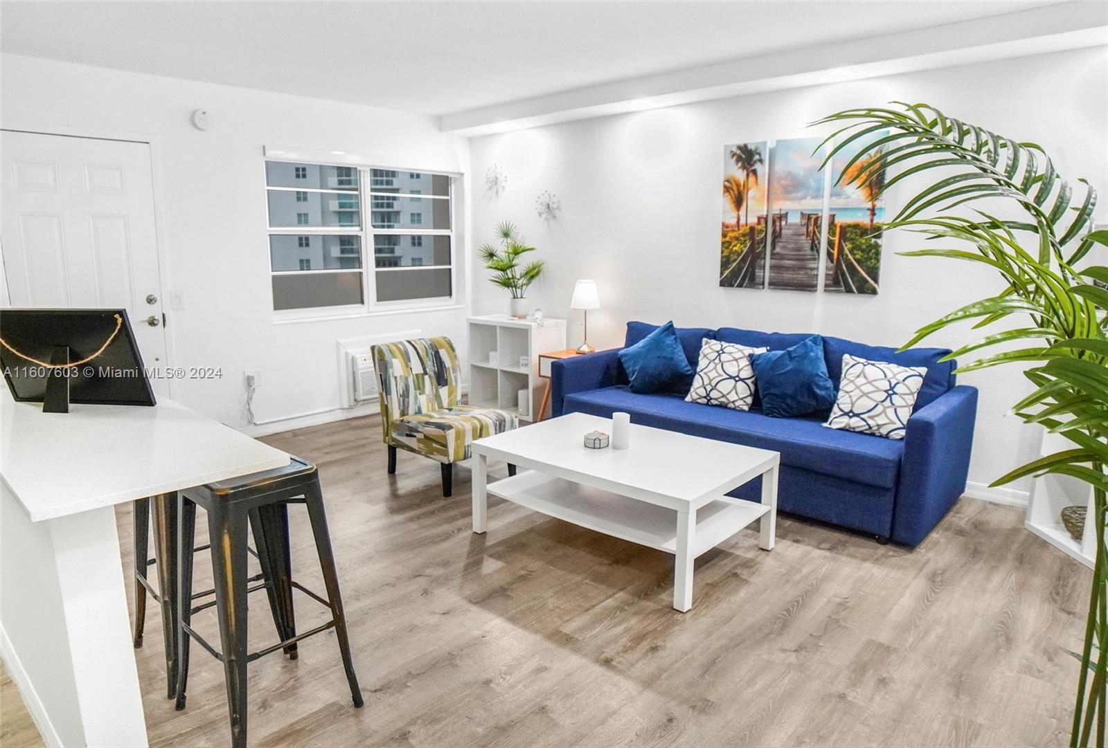 a living room with furniture and next to a window