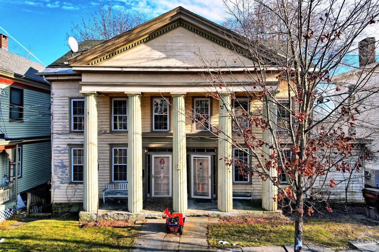 a front view of a house with street view