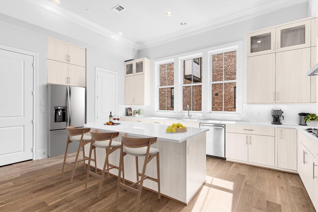 a view of a kitchen area with furniture and wooden floor