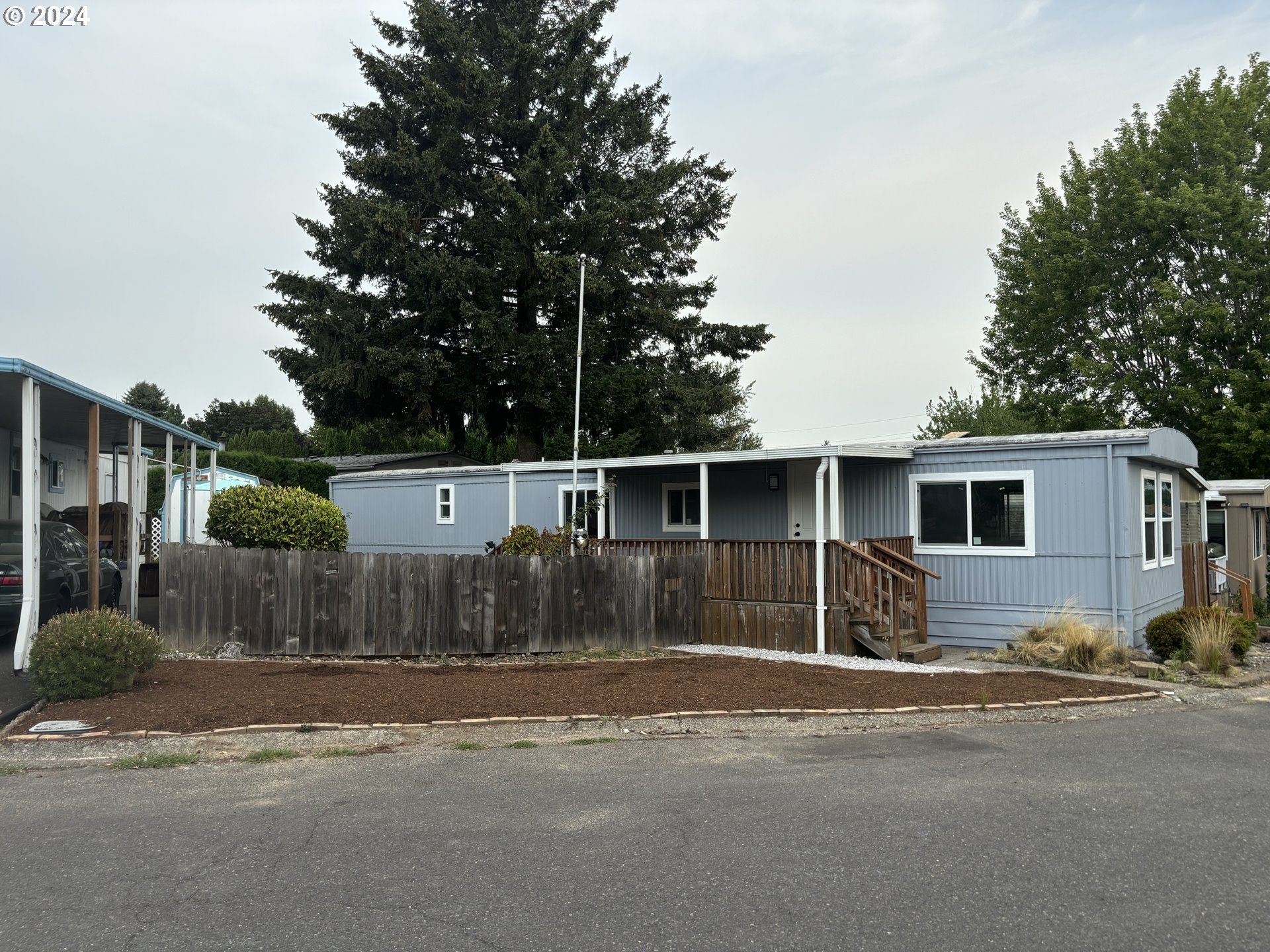 a front view of a house with trees