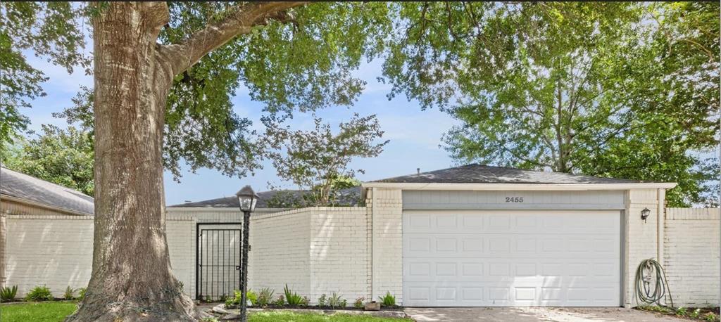 a view of house with a tree