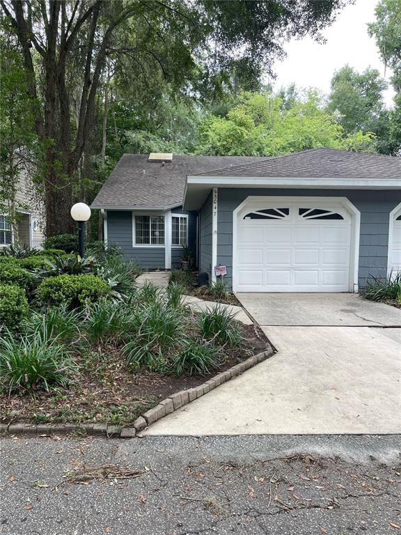 a front view of a house with a garden and garage