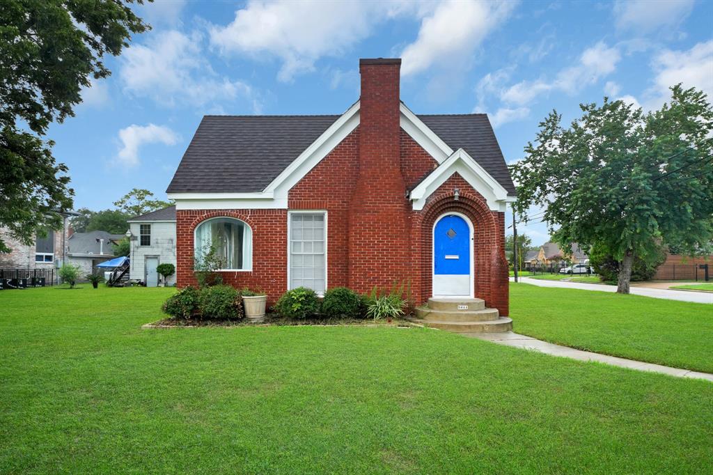 a front view of house with yard and green space