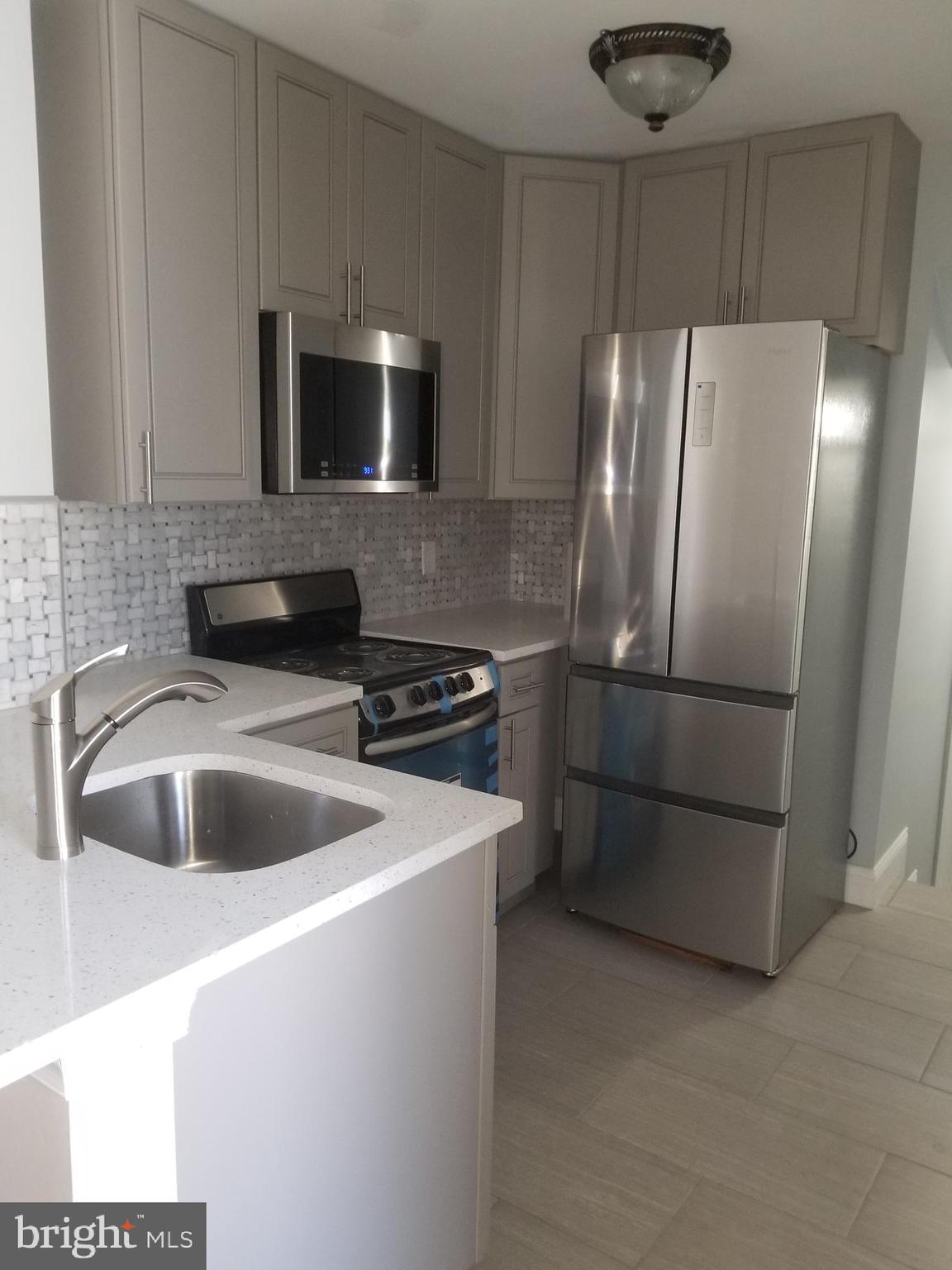 a kitchen with a sink and a refrigerator