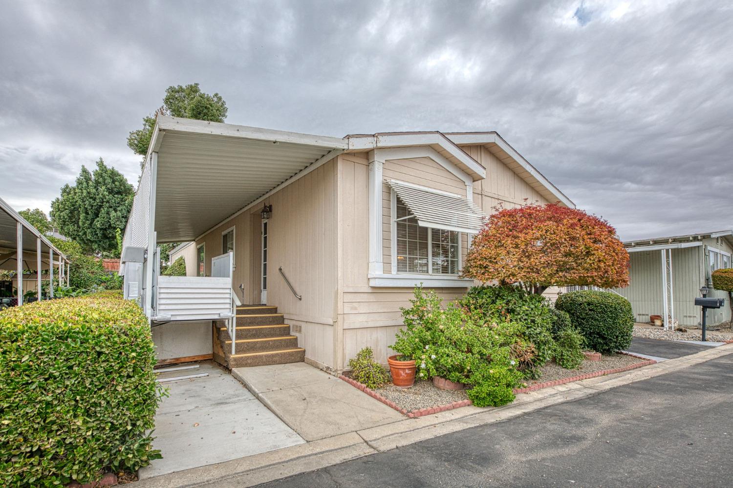 a front view of a house with a garden