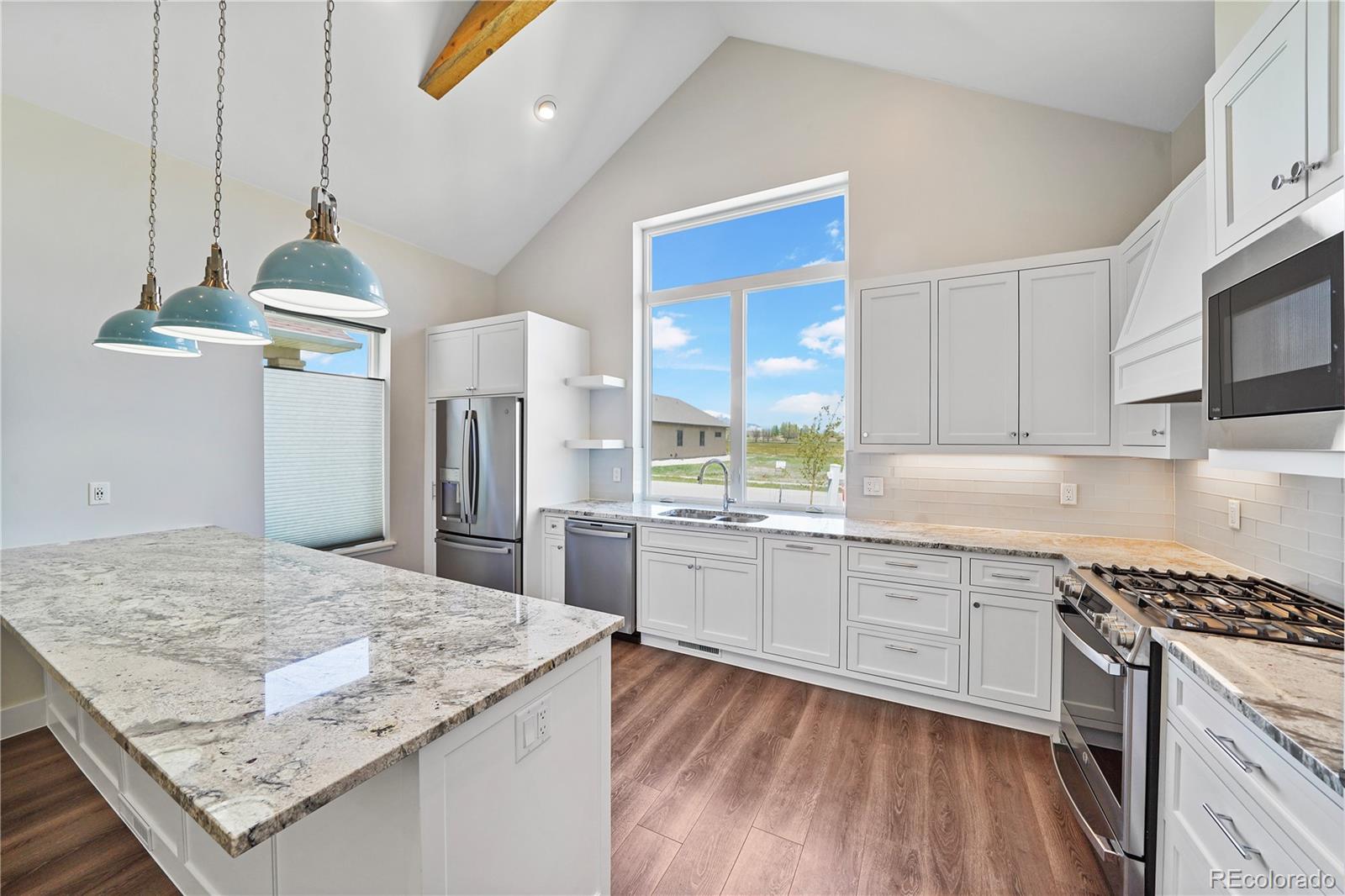 a kitchen with stainless steel appliances granite countertop wooden cabinets and a stove