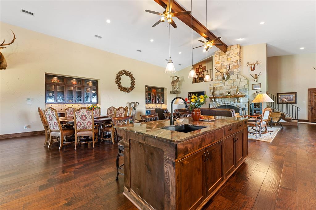 a kitchen with stainless steel appliances granite countertop a stove and a dining table