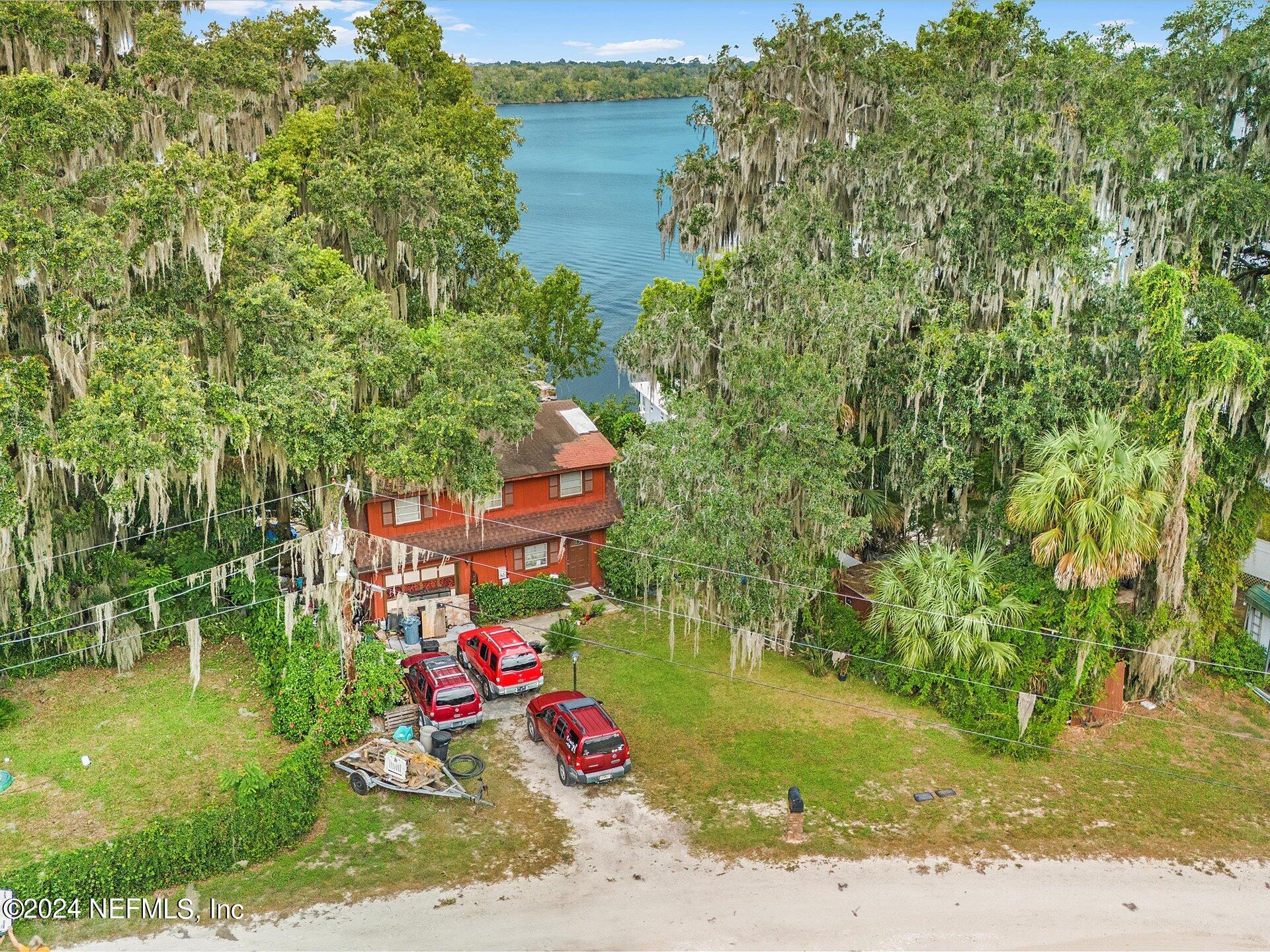 an aerial view of a house with a yard basket ball court and outdoor seating