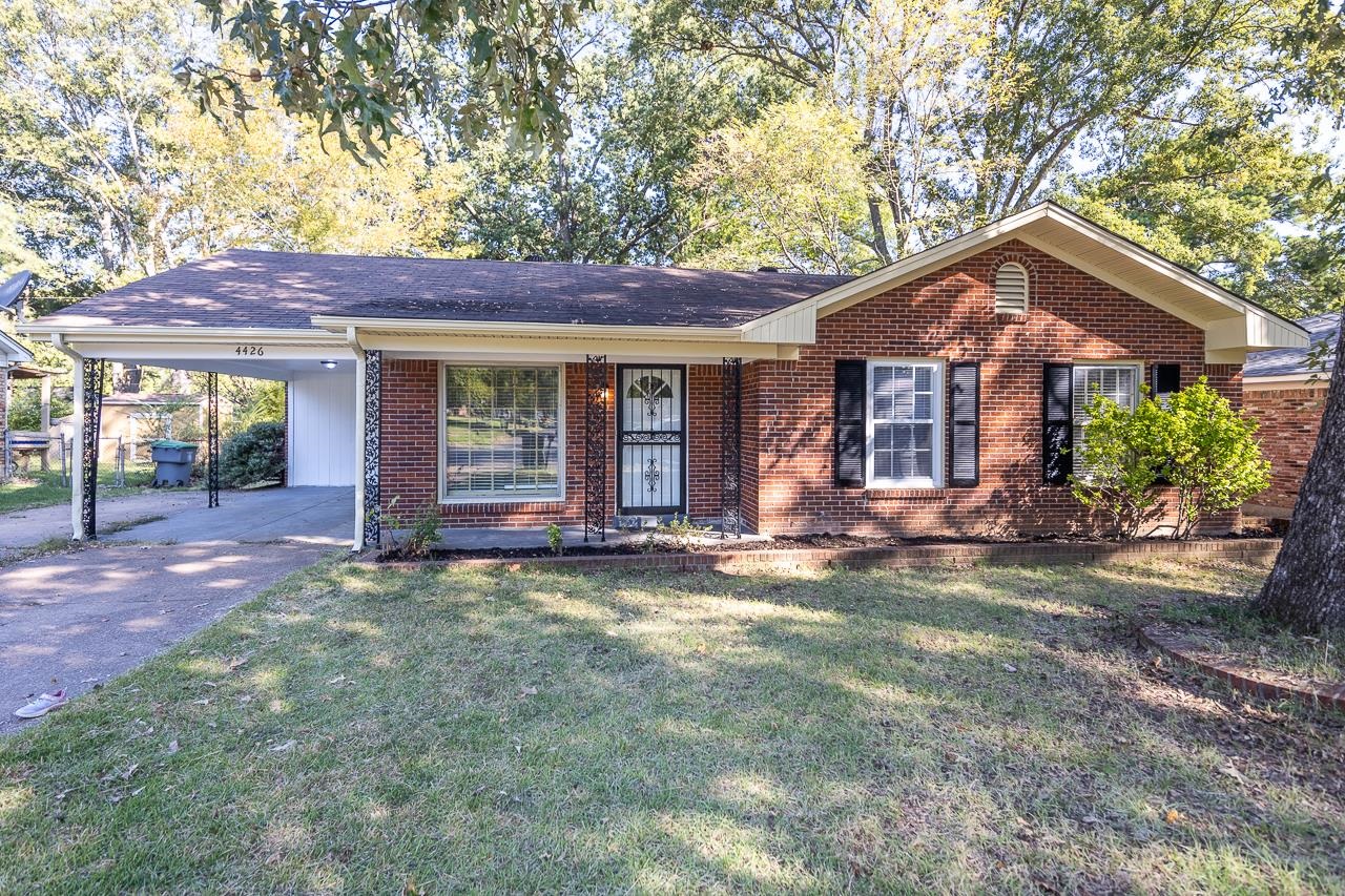 a front view of a house with yard and porch