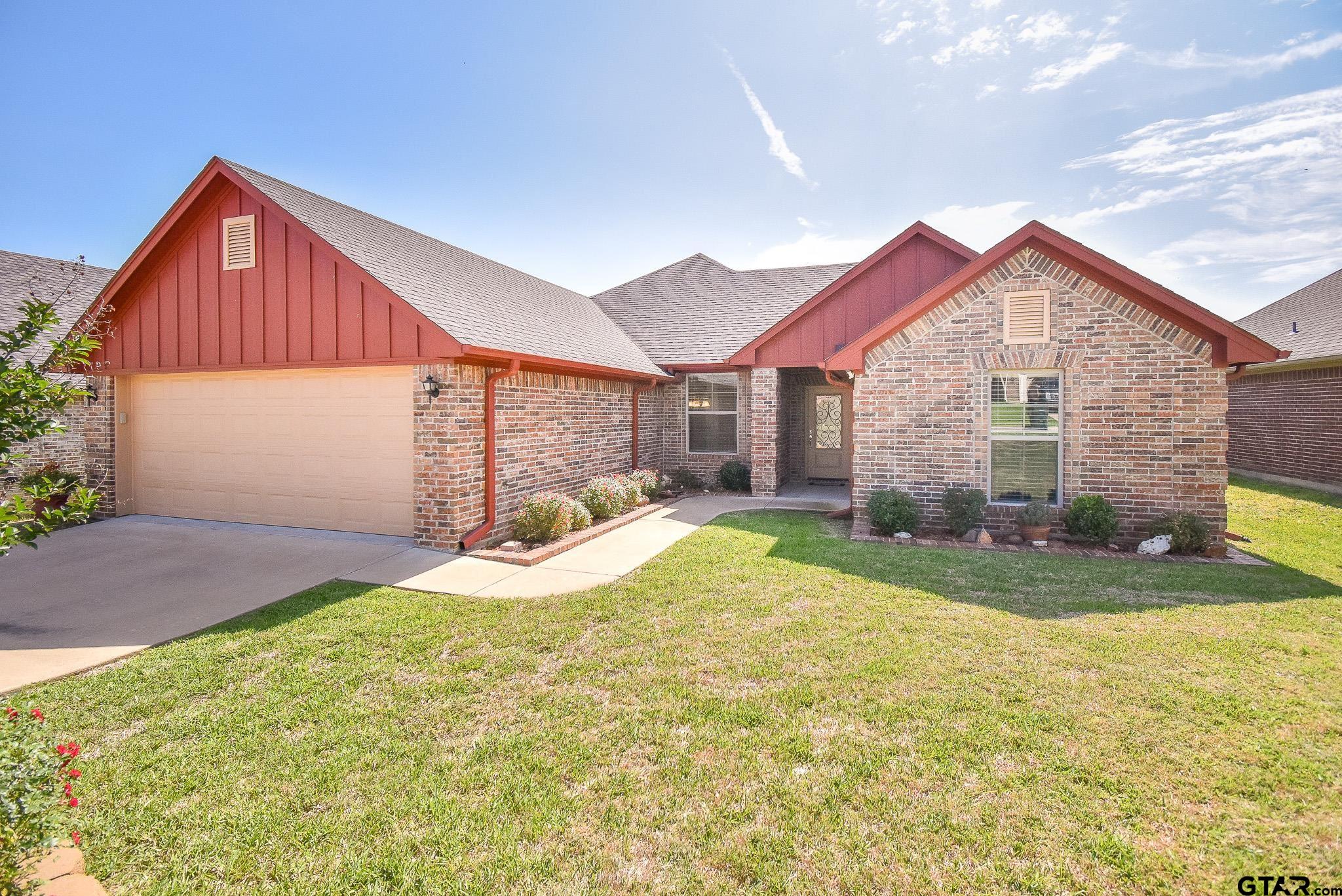 a view of a house with a yard and garage