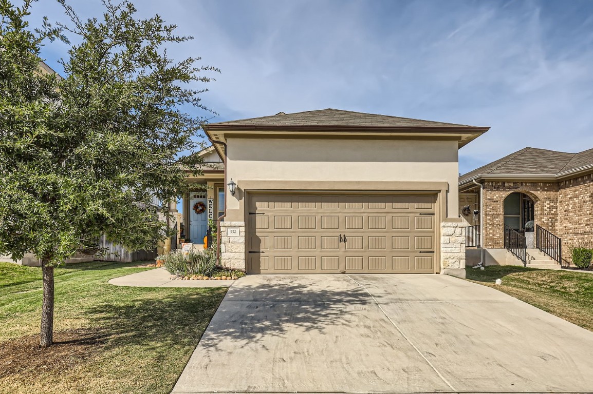 a front view of a house with a yard and garage