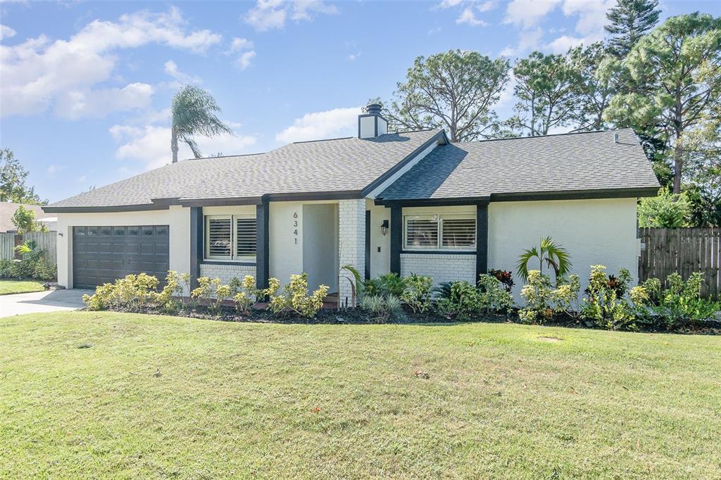 a front view of a house with garden