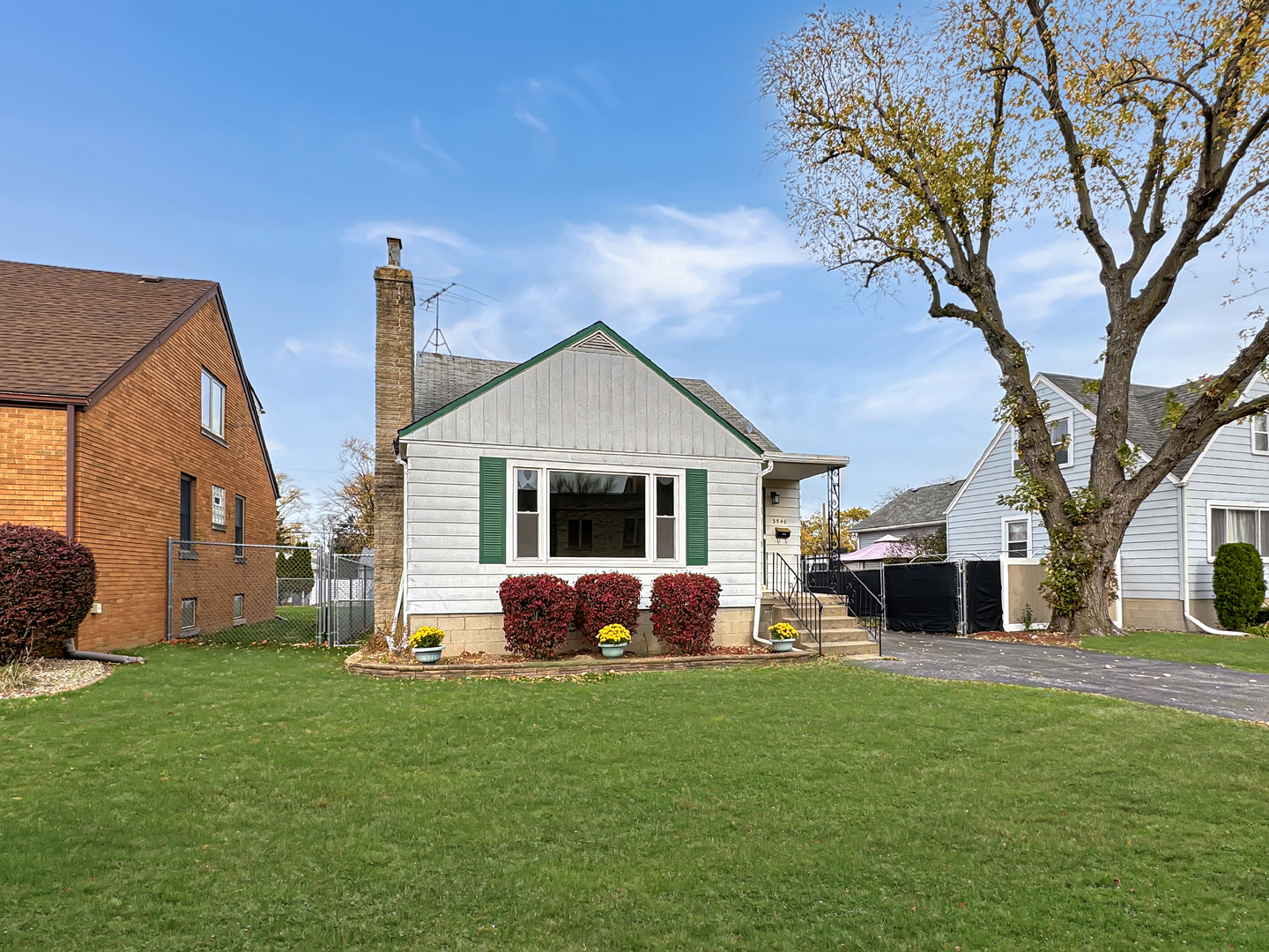 a front view of a house with a garden and yard