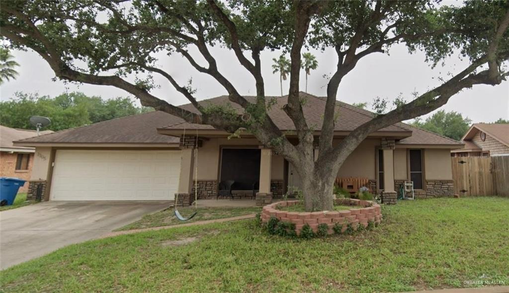 View of front of home with a front lawn and a garage