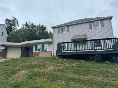 a view of a house with a yard and deck