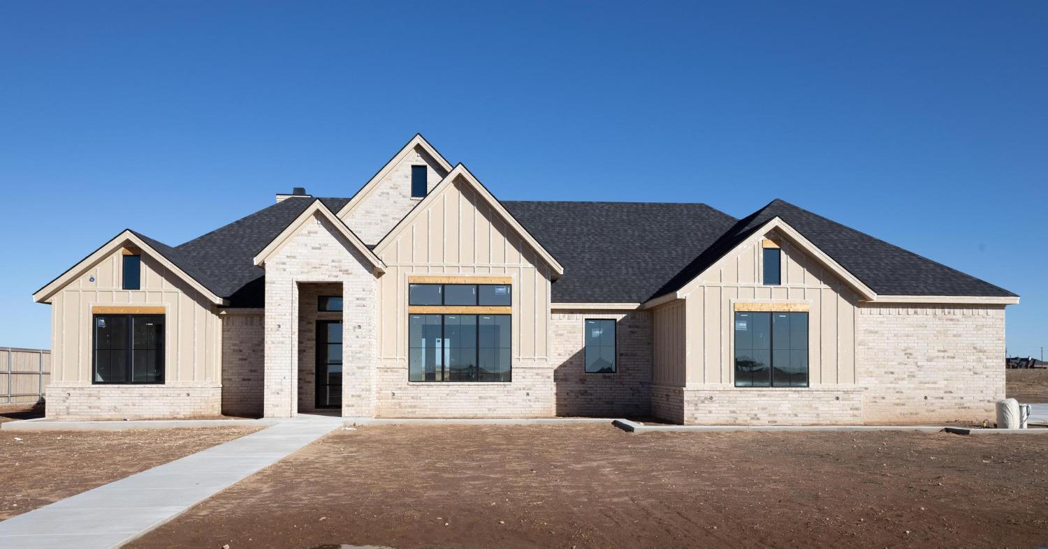 a front view of a house with yard