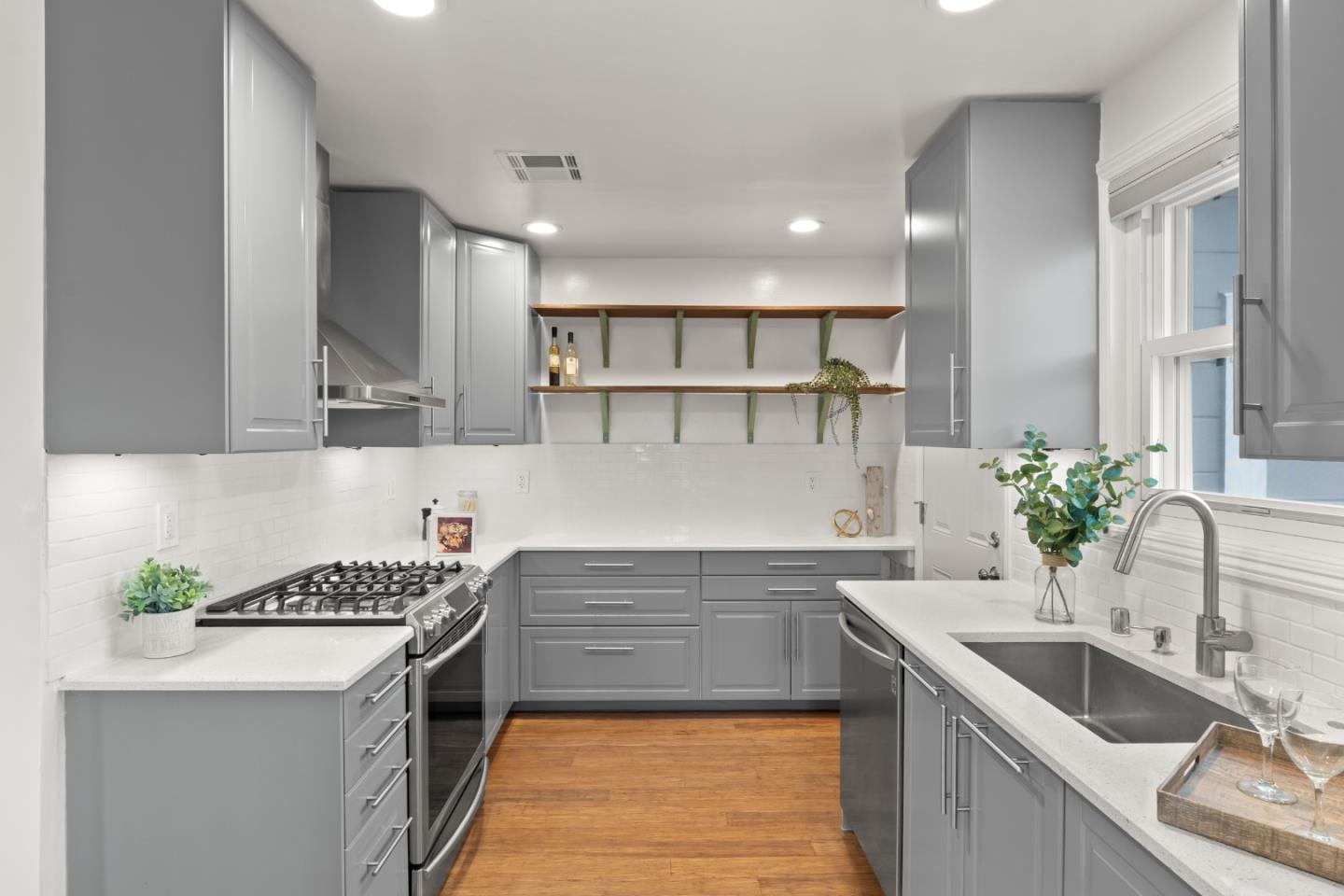 a kitchen with a sink stove and cabinets