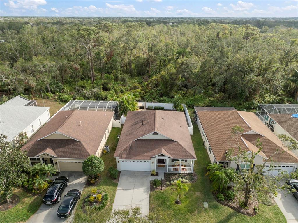 an aerial view of a house with garden space and street view