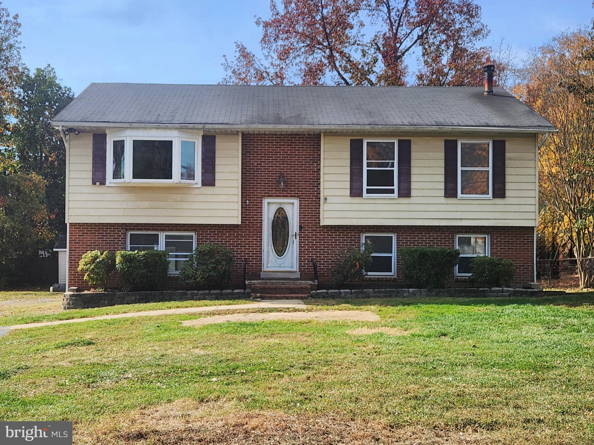 a view of house with yard in front of it