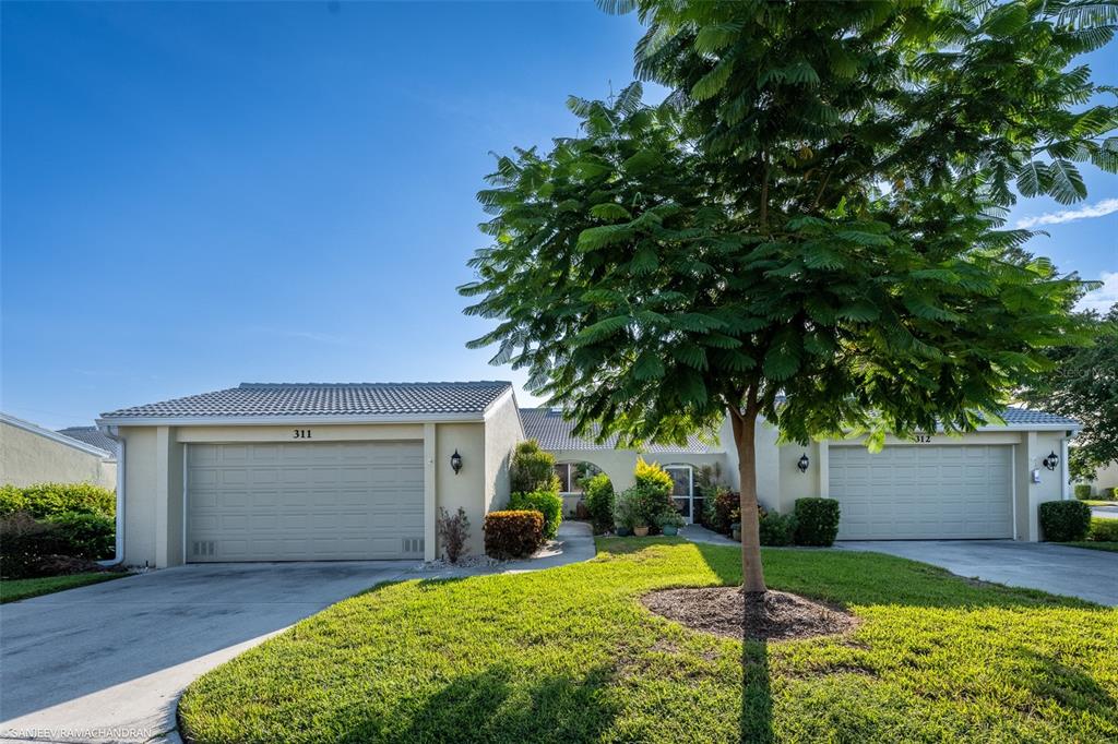 a front view of a house with a yard and garage