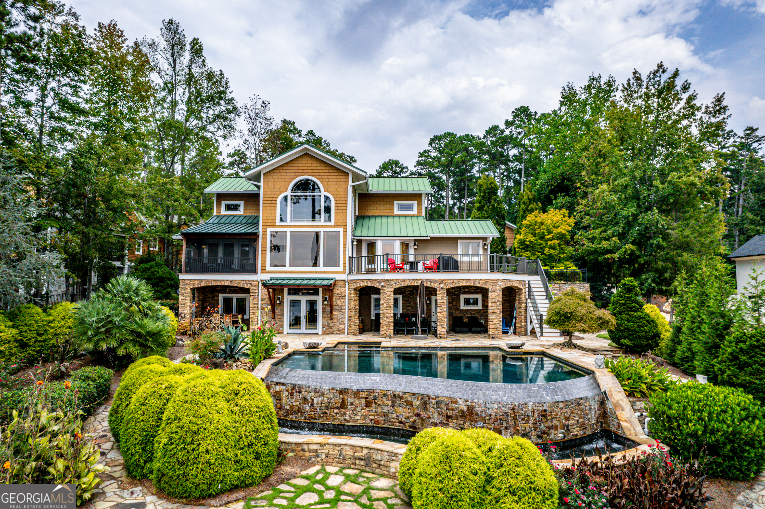 a front view of a house with a garden