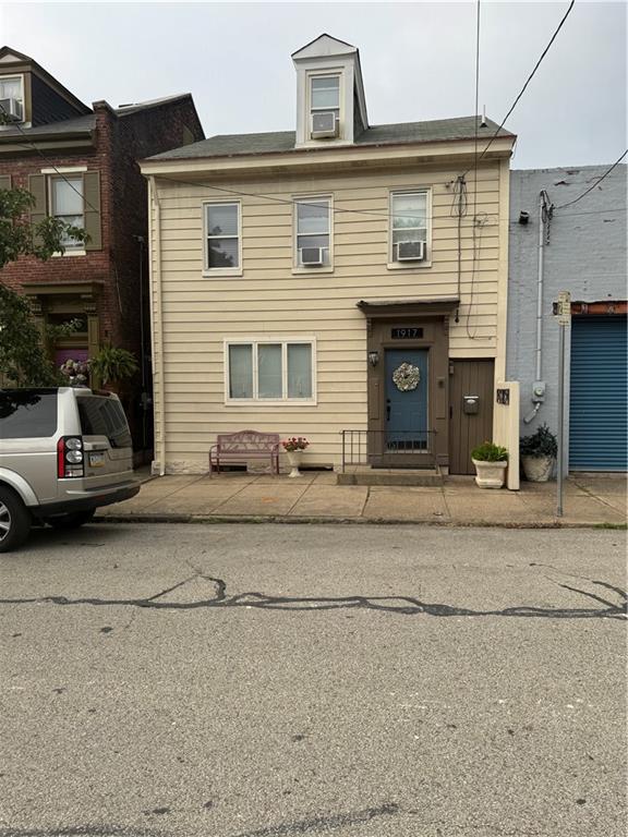 a front view of a house with car parked