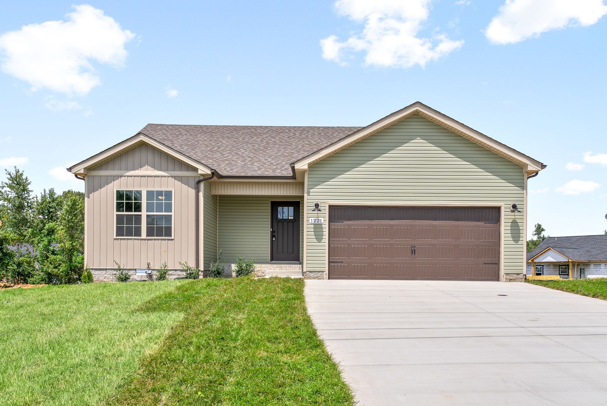 a front view of house with yard and garage