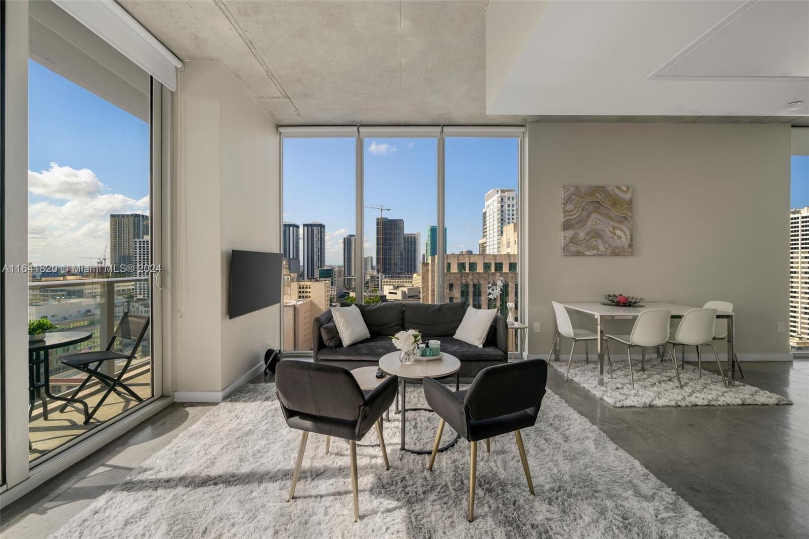 a living room with furniture and a floor to ceiling window