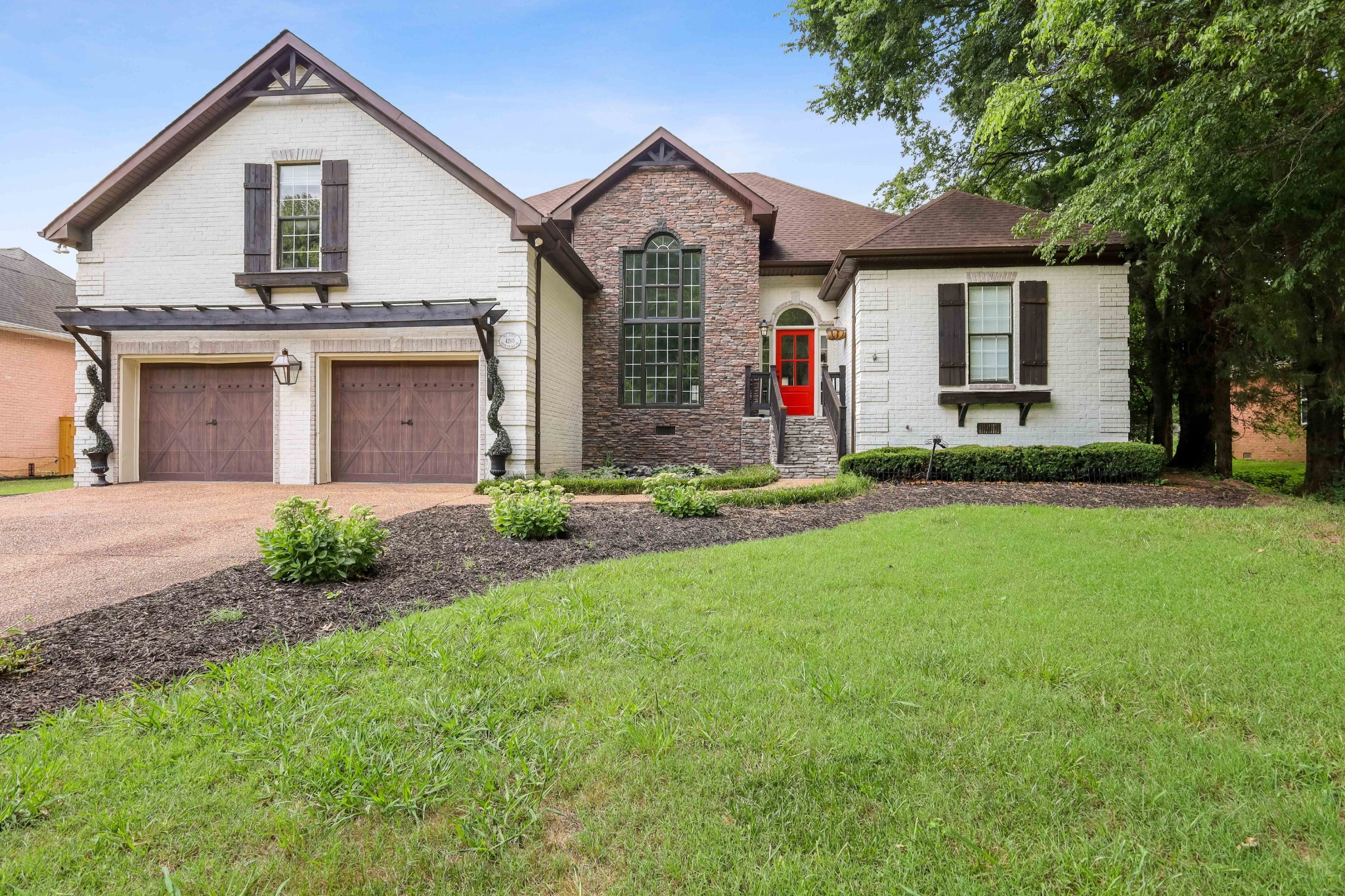 a front view of a house with a yard and garage